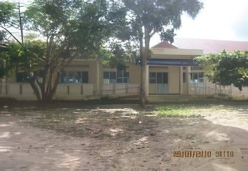 Single-story building with a sign above the entrance, surrounded by trees and an uneven dirt ground, dated "2019/02/09" in the lower right corner.