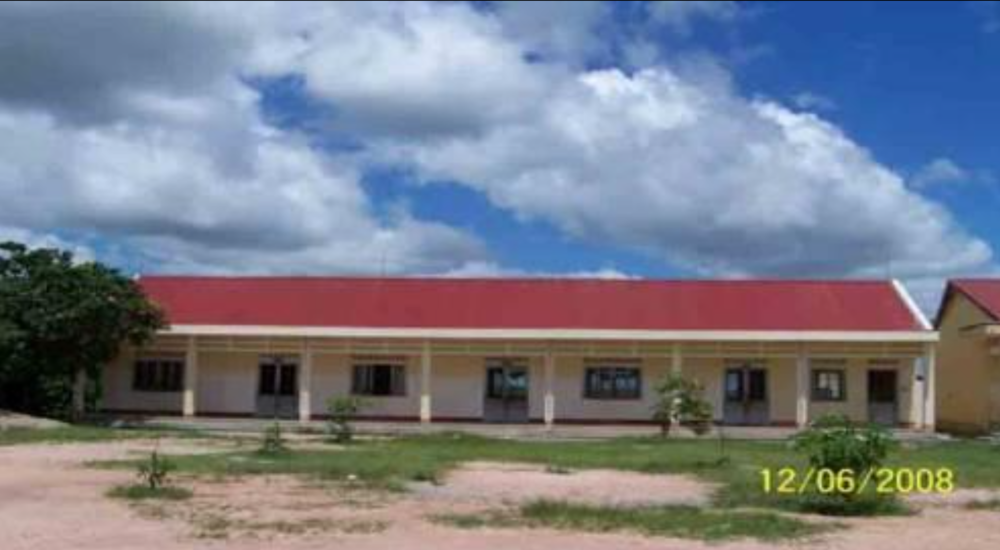 A single-story building with a red roof and several windows under a cloudy sky. The date "12/06/2008" is visible in the lower right corner.