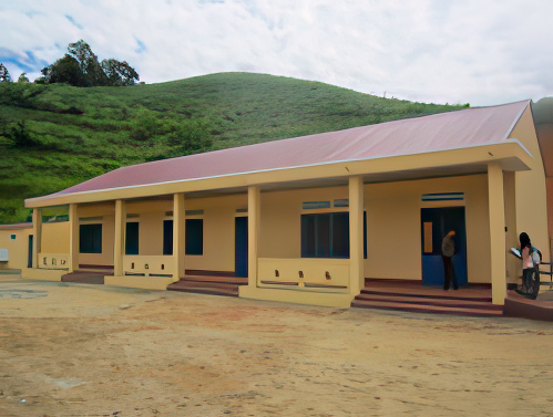 A single-story building with a red roof, beige exterior, blue doors, and windows. It is situated in a hilly, grassy environment. There are a few people near the entrances.