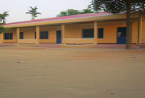 A single-story yellow building with blue doors and windows, surrounded by trees and an empty paved area in the foreground.