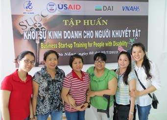 Group of six individuals standing in front of a banner with text about business startup training for people with disabilities